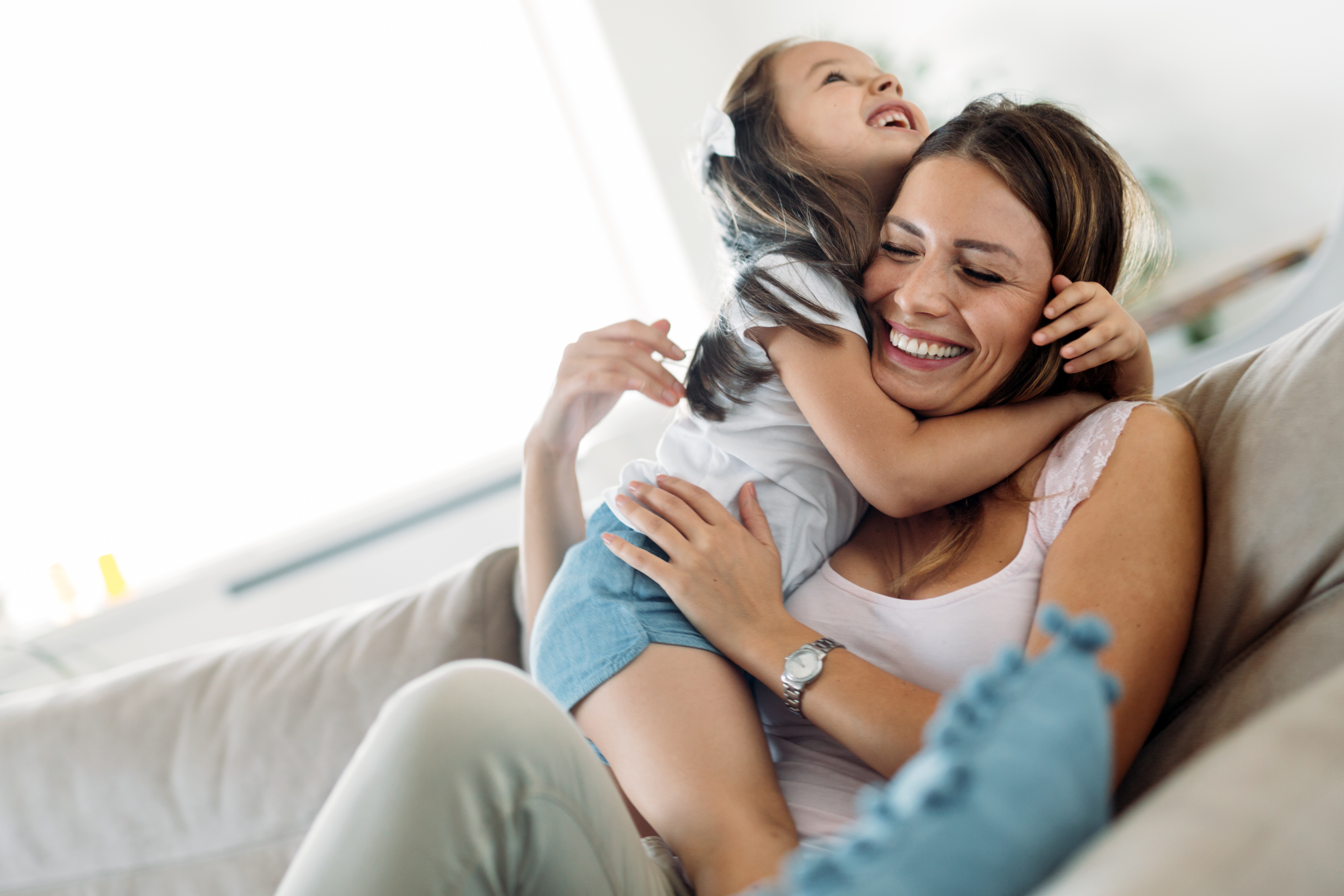 Family sitting on couch smiling stock image
