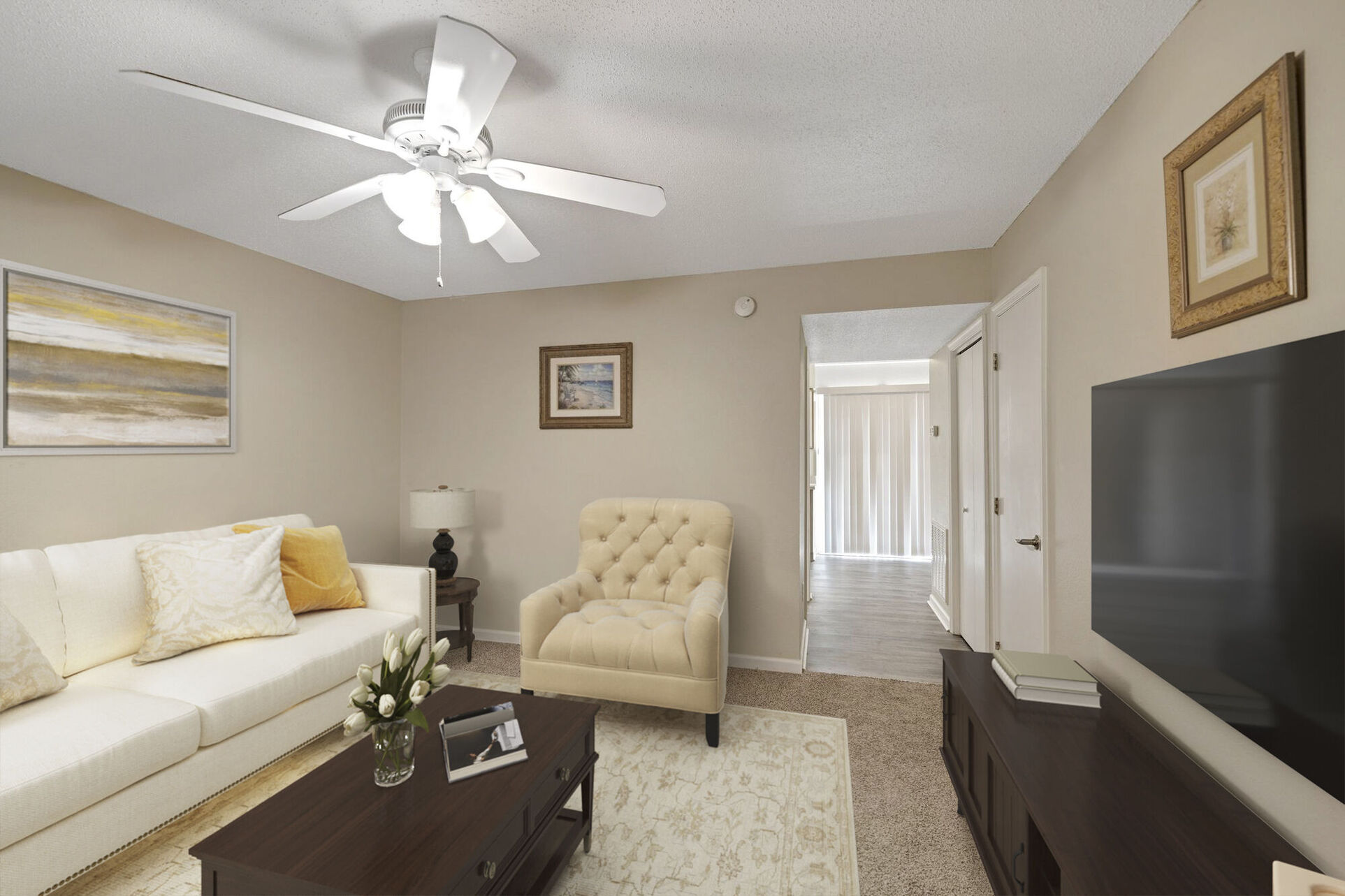 Living area with sofa, coffee table, and tv with view of hallway