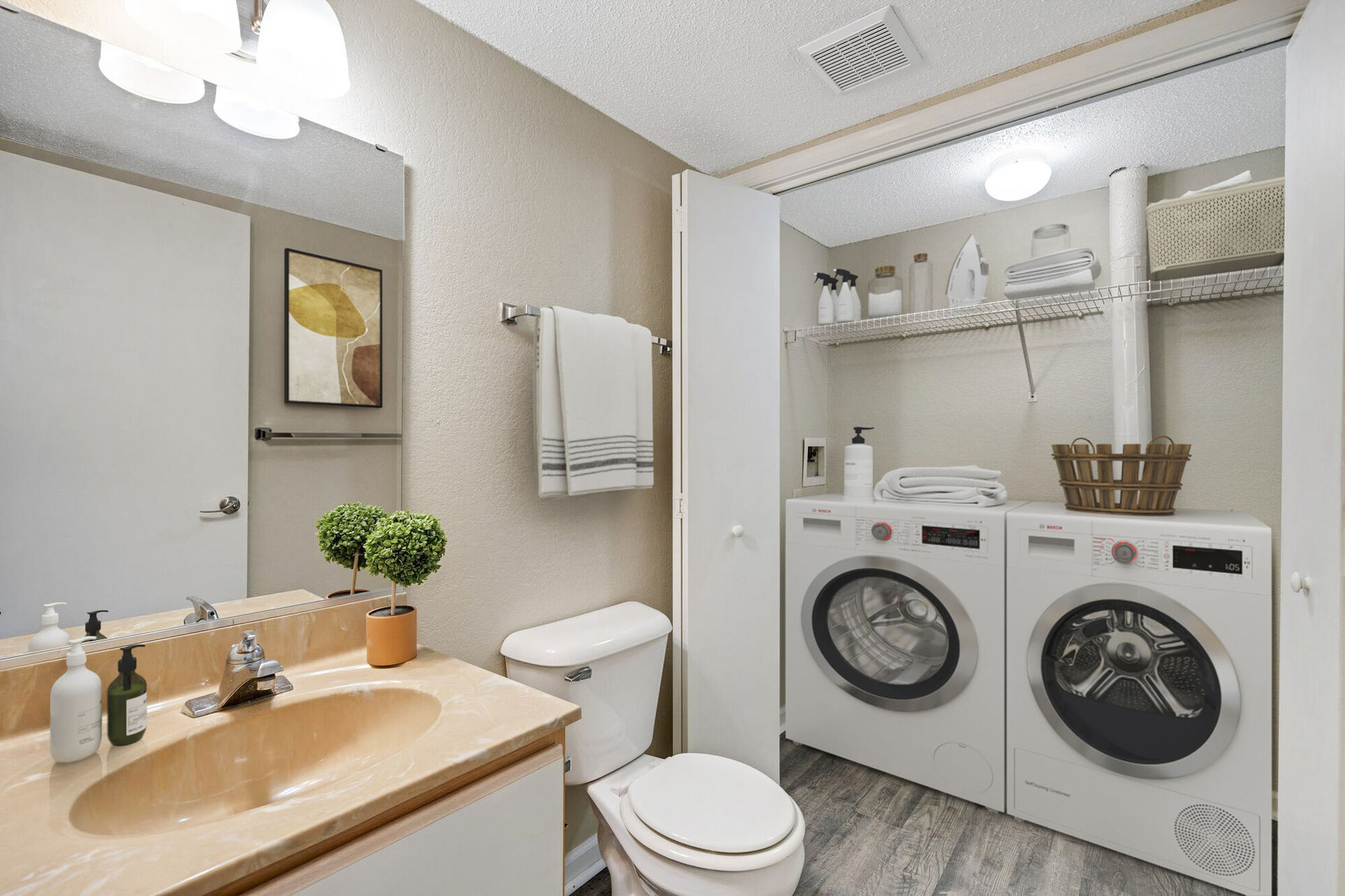 Bathroom with laundry closet with white appliances