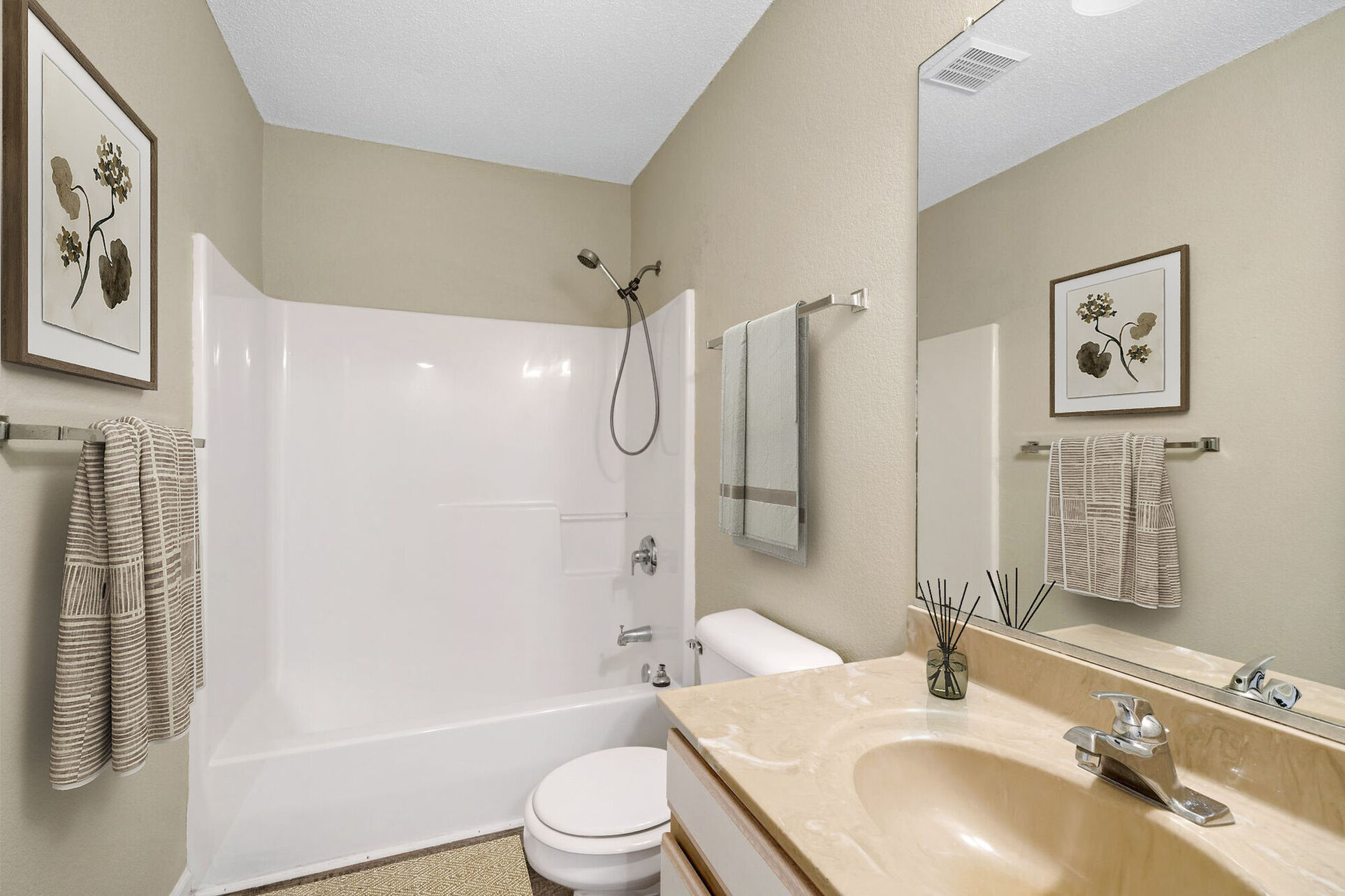 Bathroom with tub shower combo and brown and white vanity