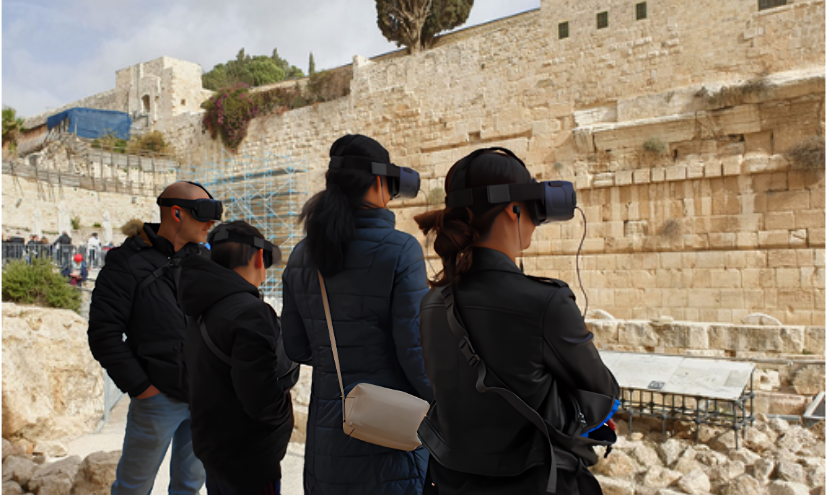 Four people wearing VR headsets stand near a historic stone wall outdoors.