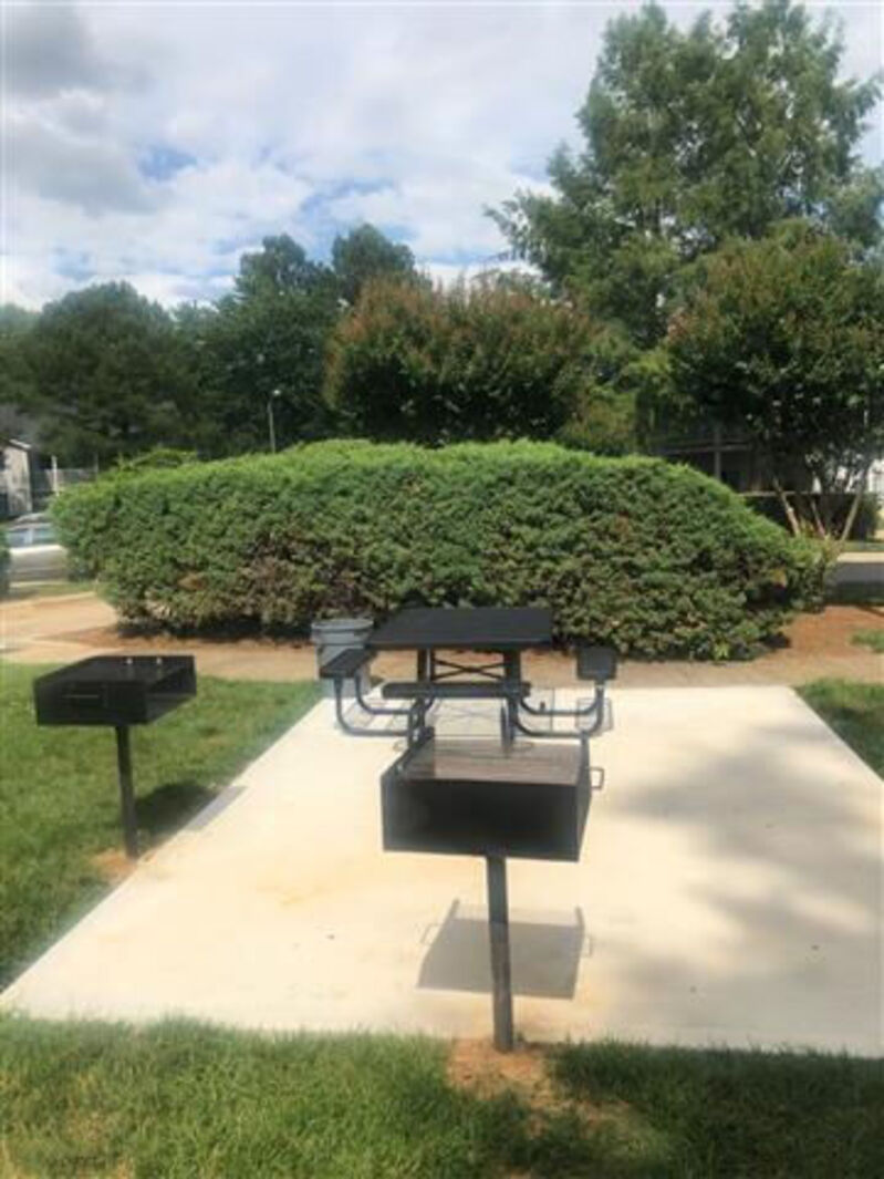 Outdoor area with bench and barbecue