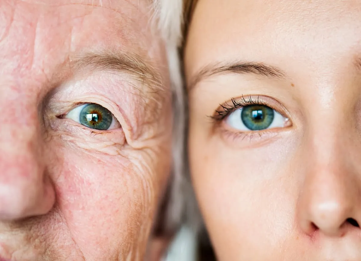 Close-up of an elderly man's and a young woman's faces showing their green eyes side by side.