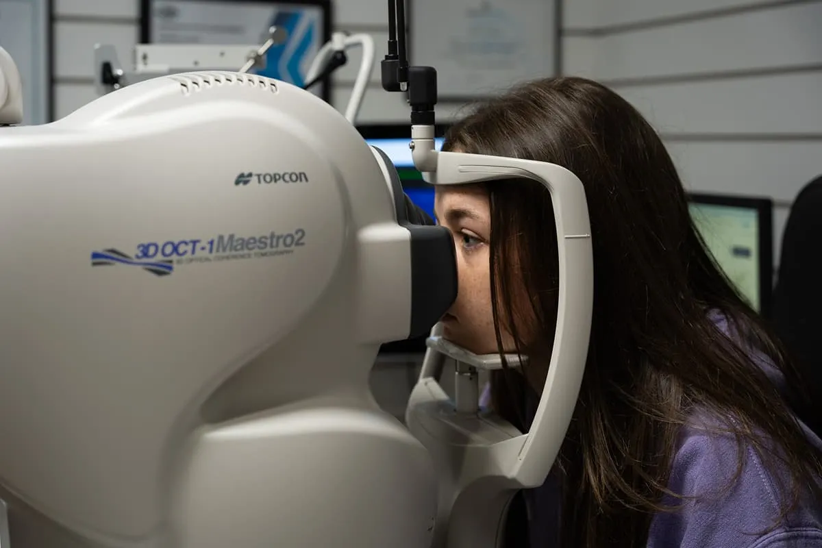 Woman undergoing an eye exam with a Topcon 3D OCT-1 Maestro2 optical coherence tomography machine.