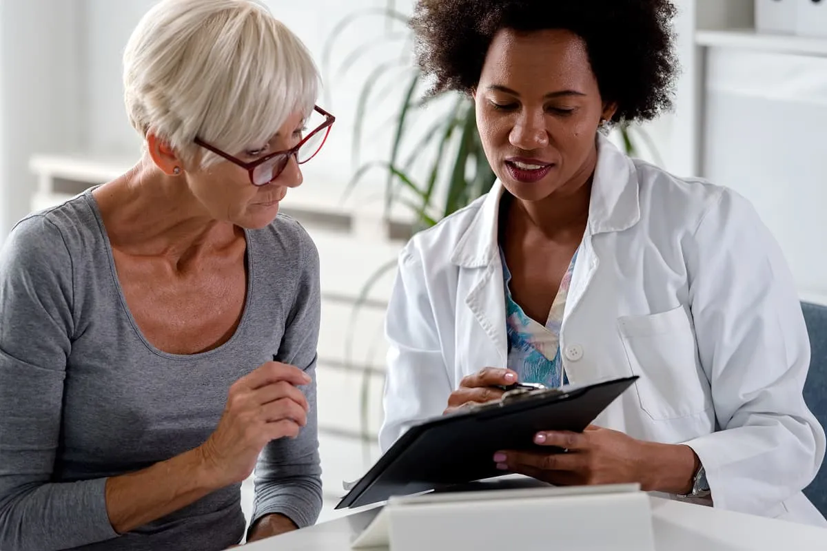 Woman seated with an audiologist during a hearing test