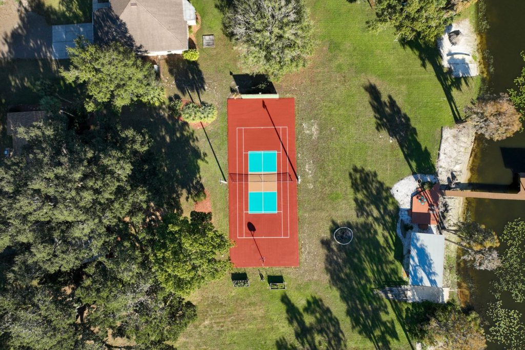 Completed three-color tennis and pickleball court resurfacing at Graves Residence in Lutz, FL