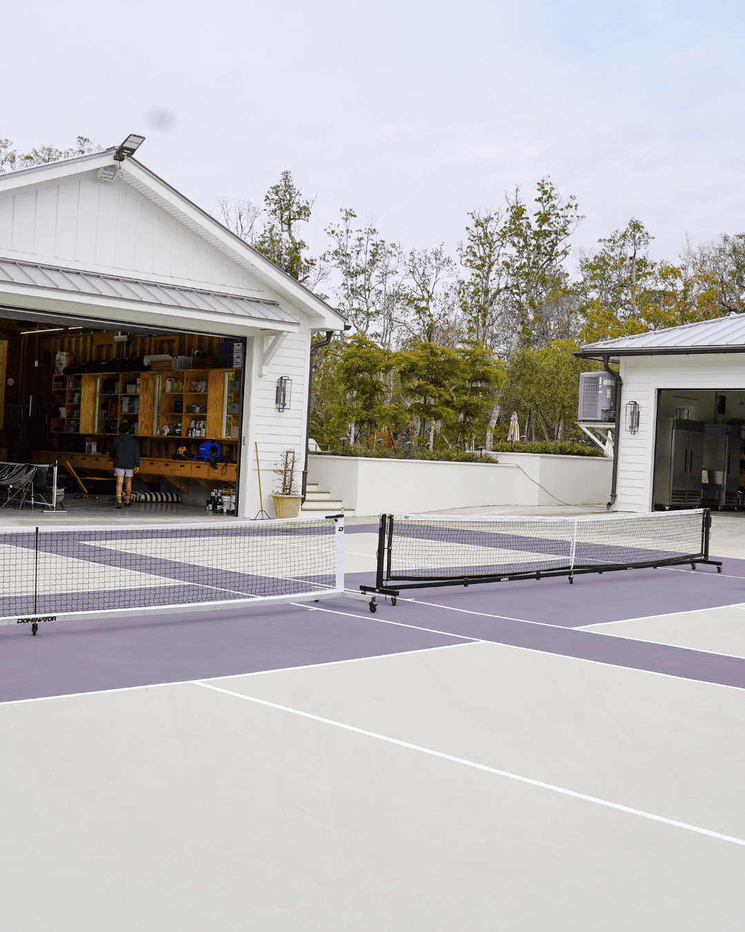 Portable Dominator net system on driveway pickleball courts at Housh Residence