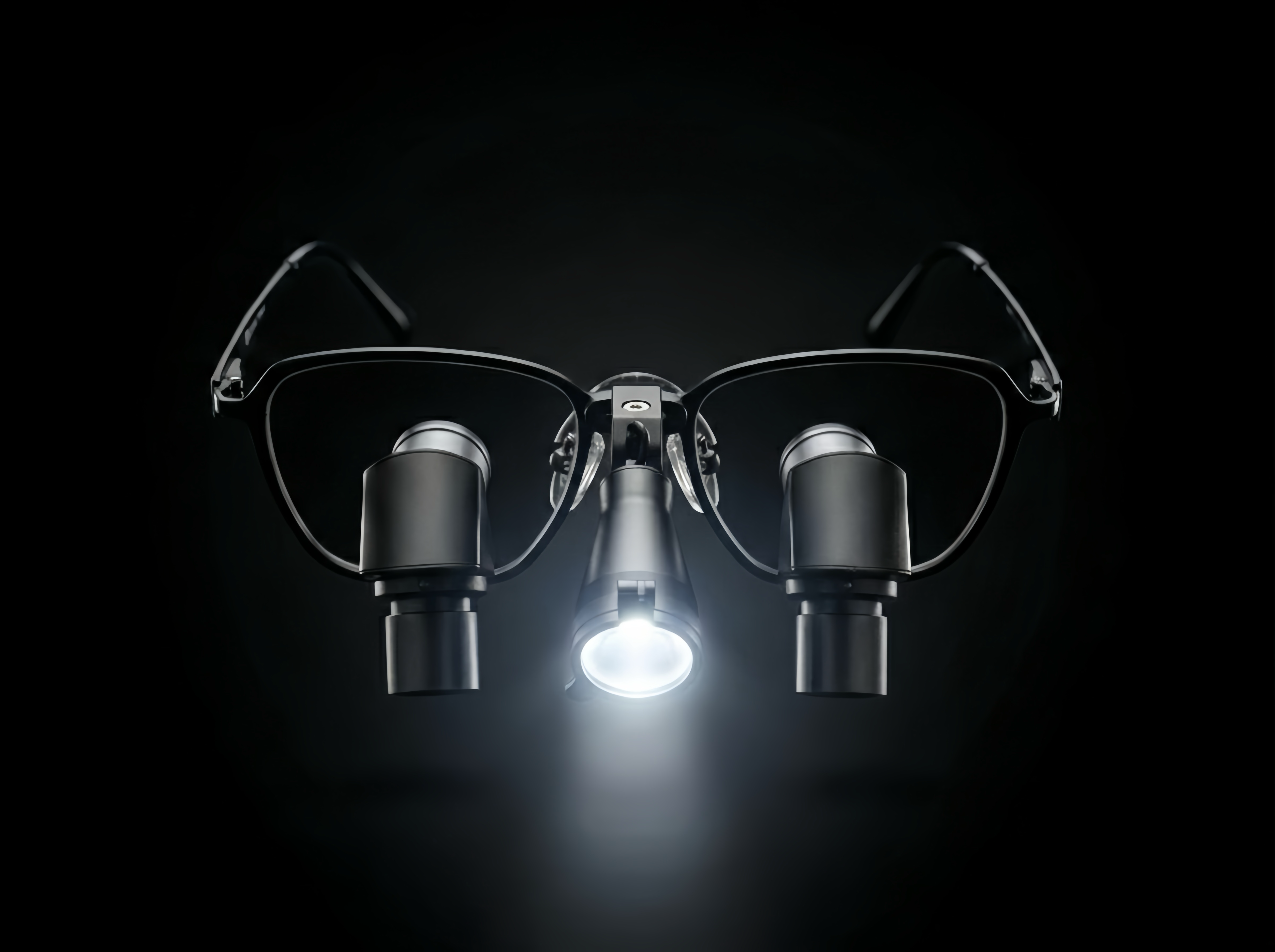 Black prismara ergonomic loupes with prismara solis against a dark background.