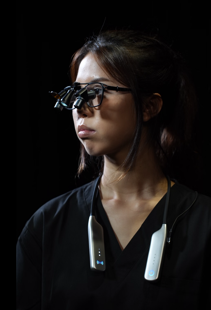 Young woman wearing black medical scrubs with prismara ergonomic loupes and a prismara solis