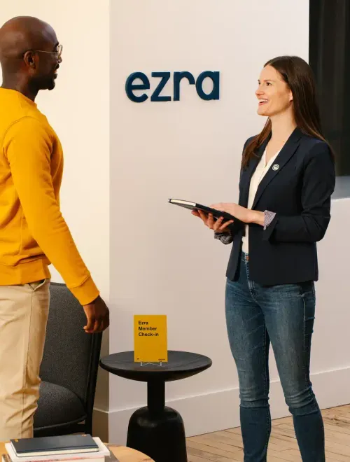 Two people in front of Ezra check in