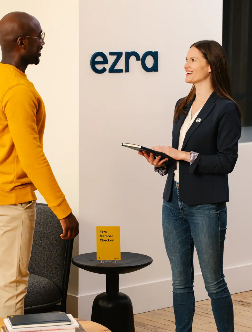 Two people in front of Ezra check in