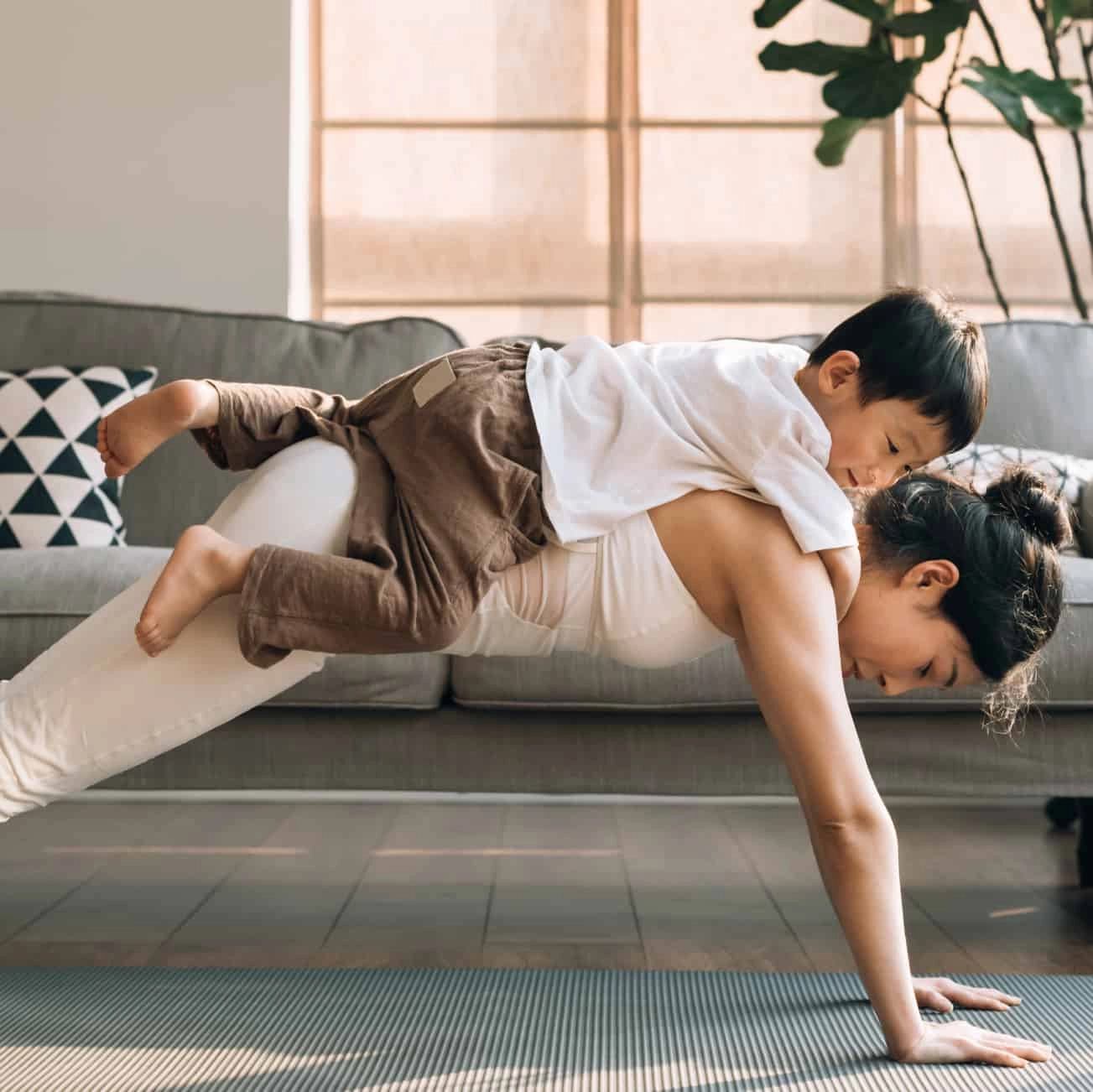 Woman doing pushups with child