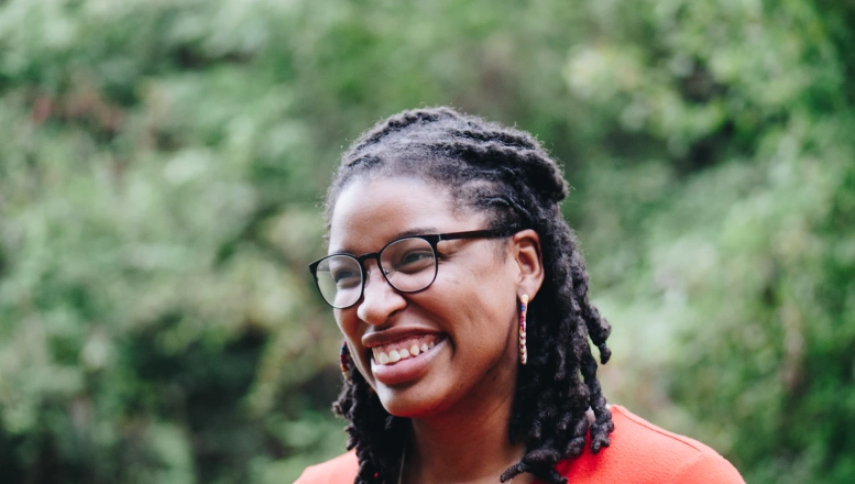 Person in front of greenary