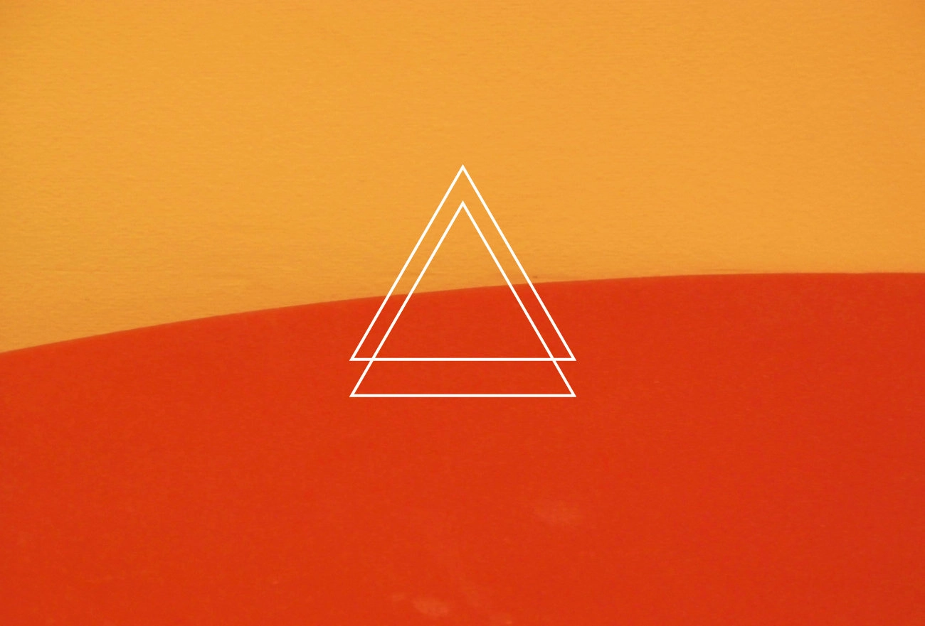 White nested triangle outlines on split golden orange and coral background