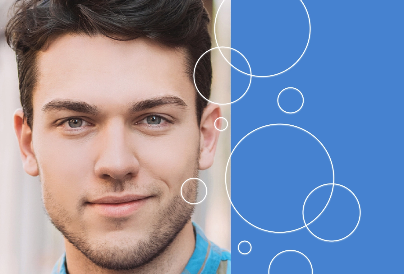 Man with beard beside white circles of varying sizes on blue background