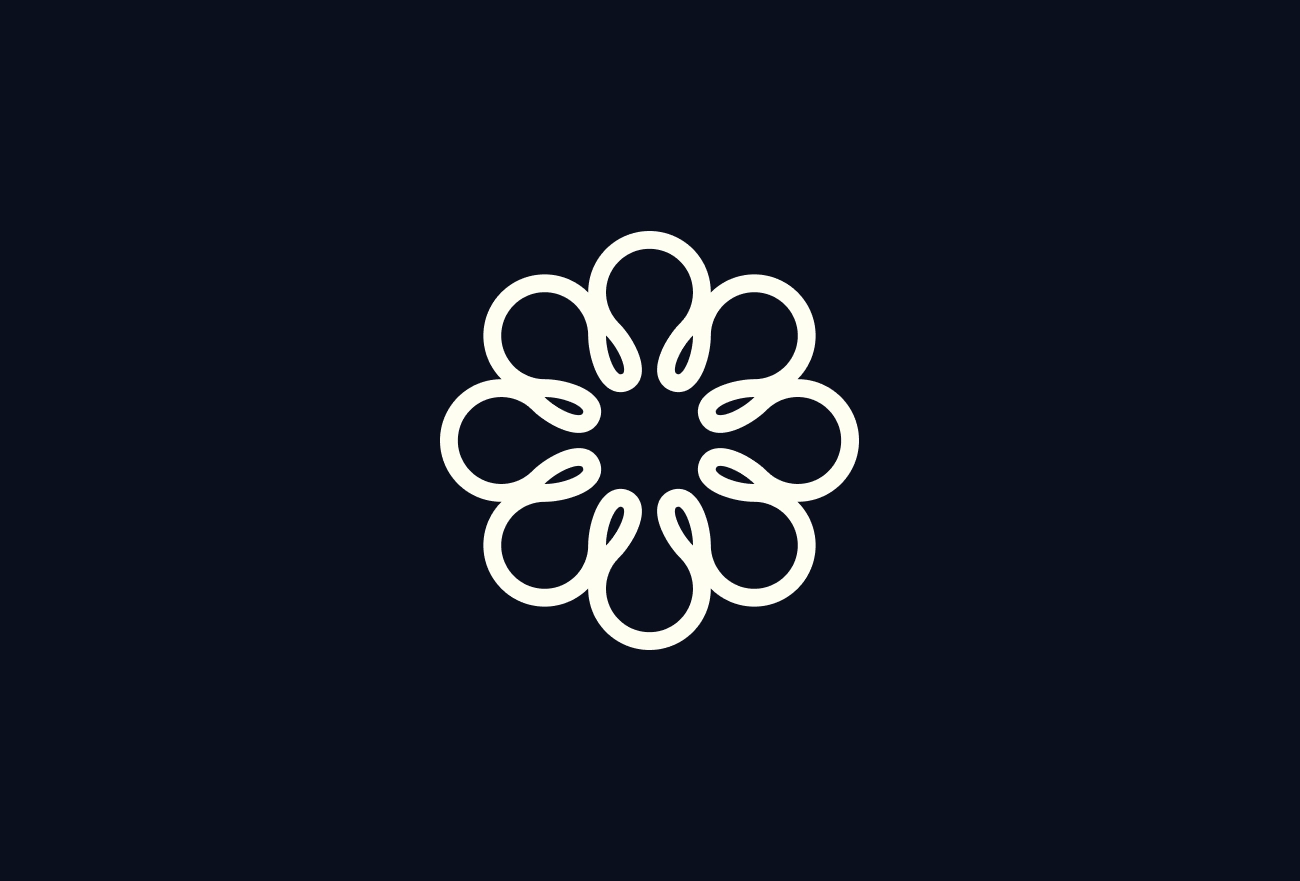 White mandala pattern with eight petal shapes arranged in circle on dark navy background