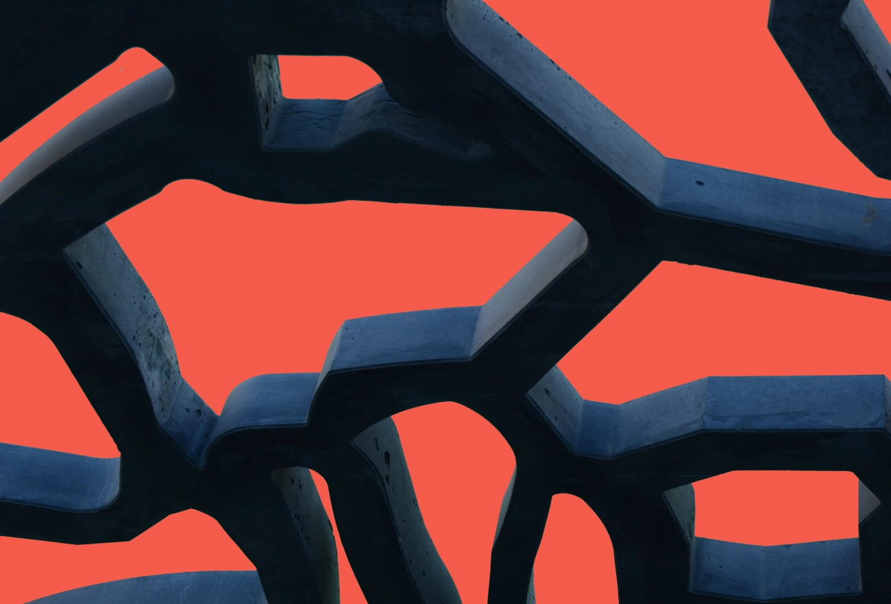 Abstract 3D pattern featuring intertwining bright red and dark blue curved geometric shapes