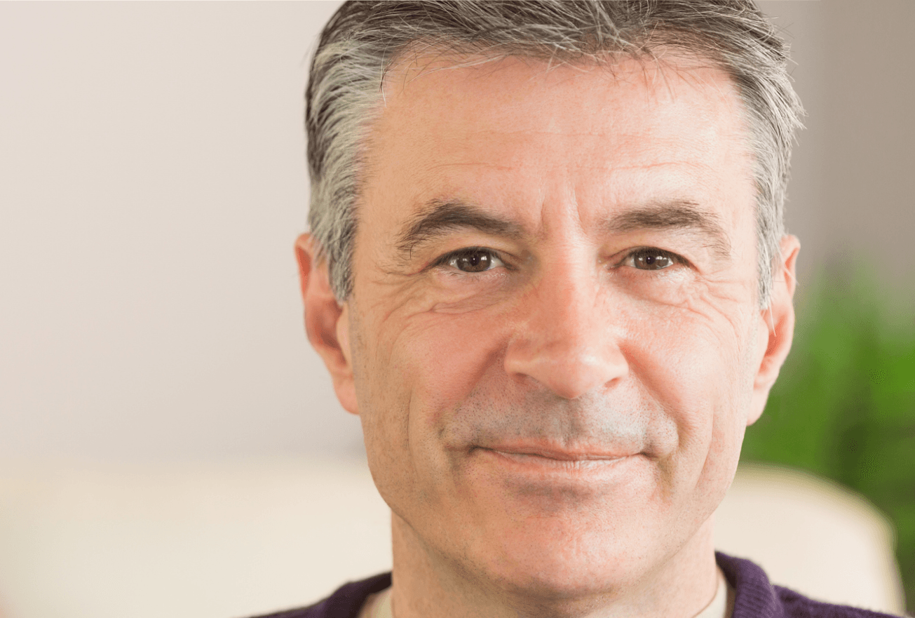 prostate cancer stages: Close up shot of a smiling, middle-aged man