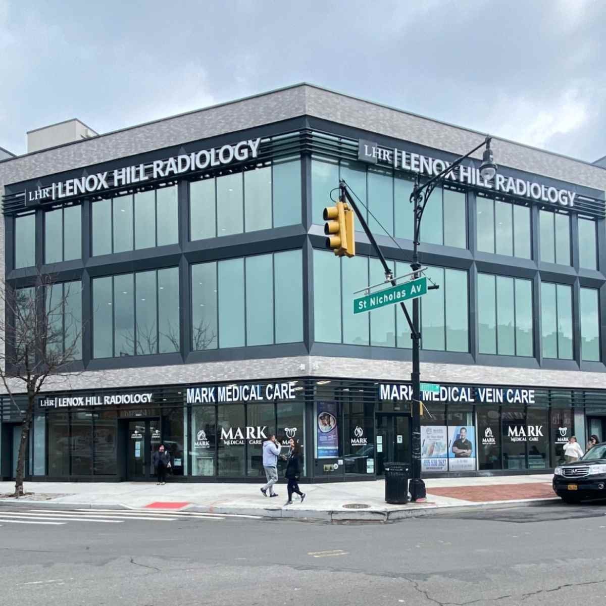 Lenox Hill Radiology medical building at St Nicholas Avenue with glass facade and ground floor storefronts