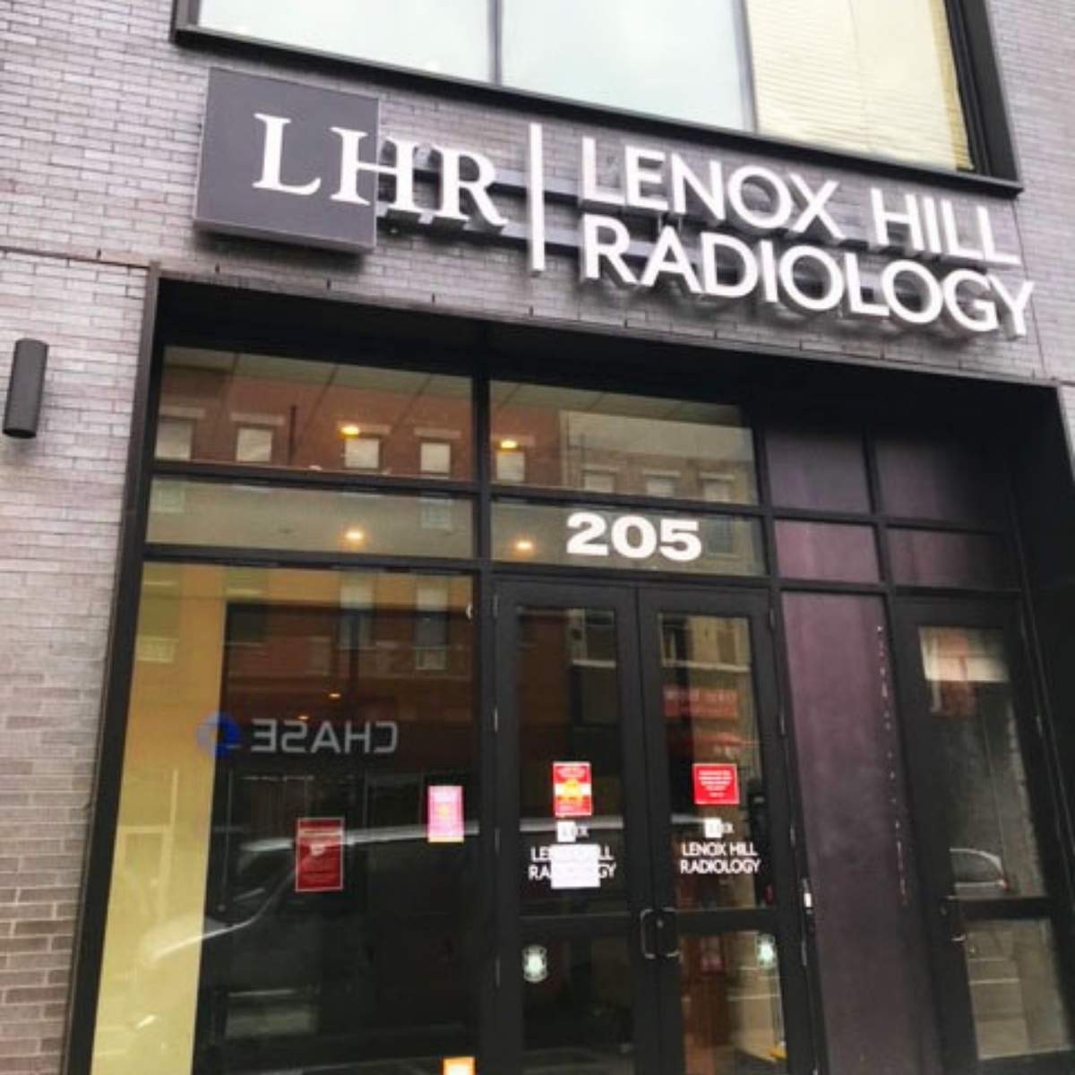 Lenox Hill Radiology storefront at address 205 with dark facade, glass windows, and signage on brick building