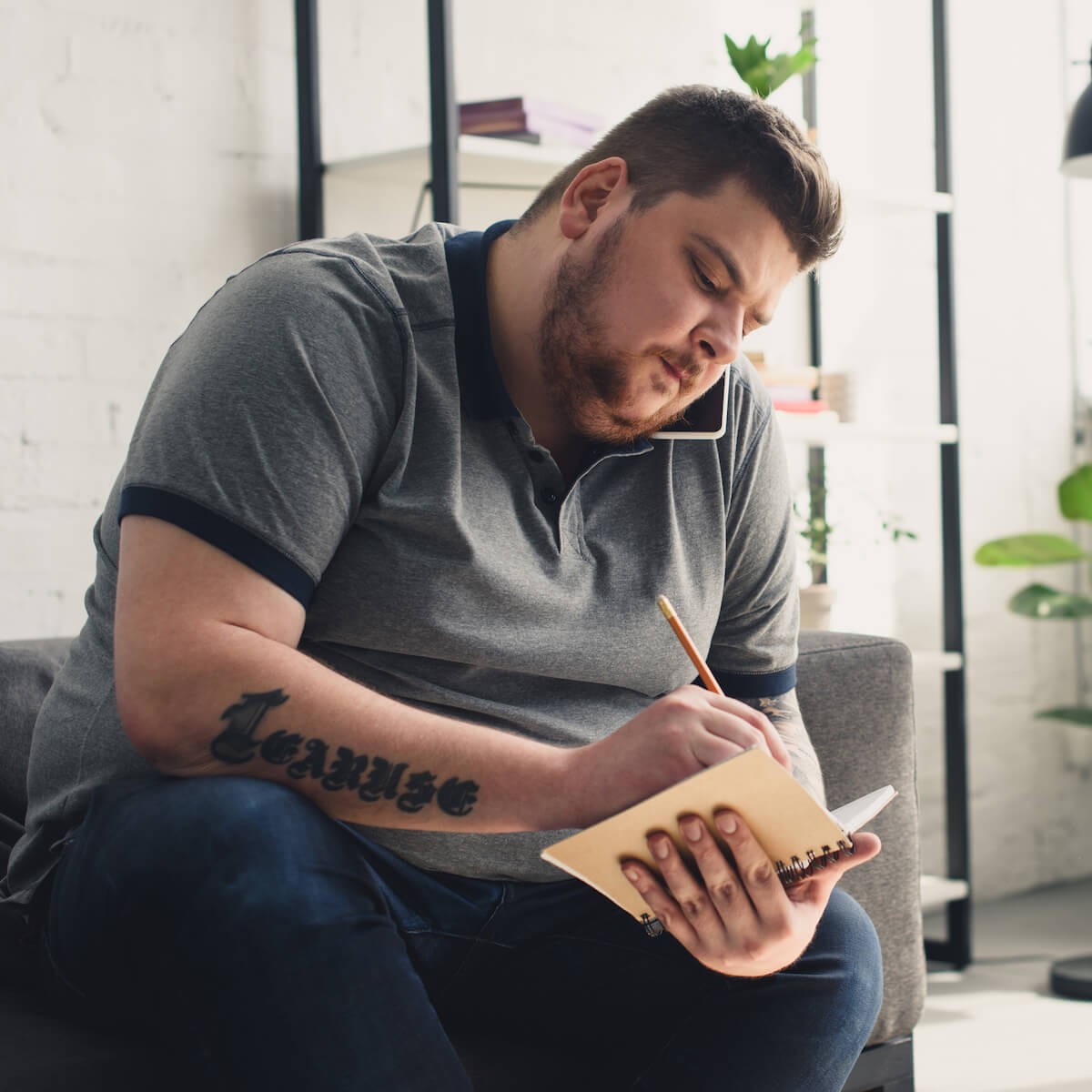 Open MRI: overweight man writing in his notebook