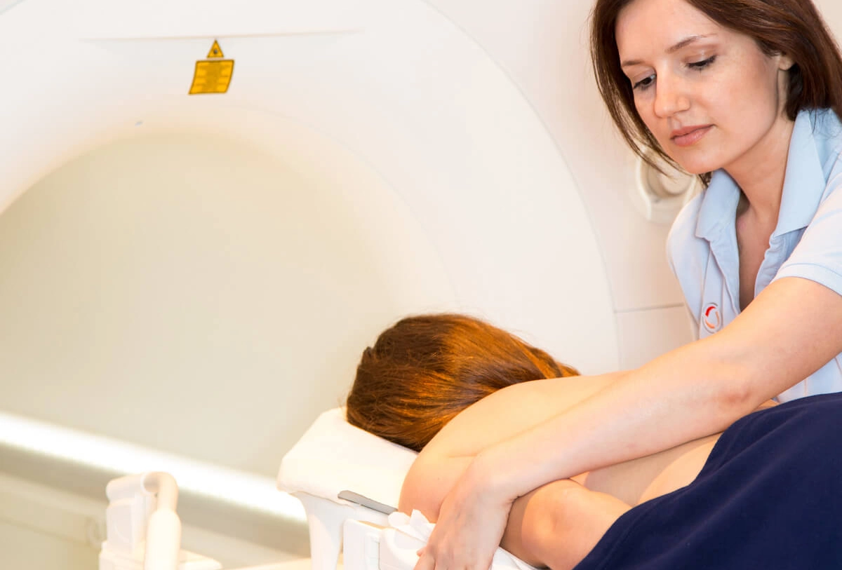 Physical therapist performing back massage on patient during treatment session