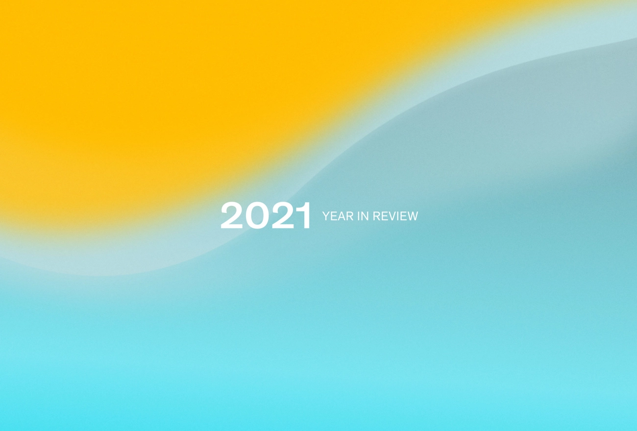 2021 Year in Review text on gradient background transitioning from yellow to turquoise