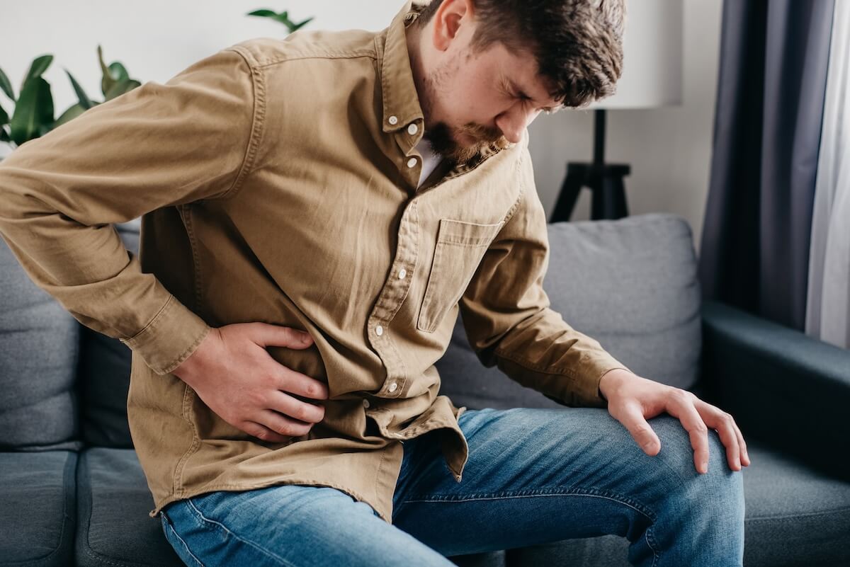 What is the function of the liver: man holding his belly