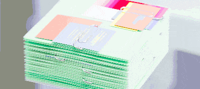 Stack of colorful circuit boards with various electronic components being assembled or inspected.