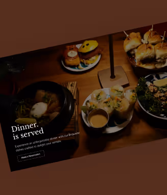Table set with plates of assorted gourmet appetizers including sliders, spring rolls, salad, and a bowl with an egg on top, with text stating 'Dinner is served'.