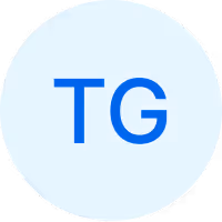 Blauer Kreis mit den weißen Buchstaben TG in der Mitte.