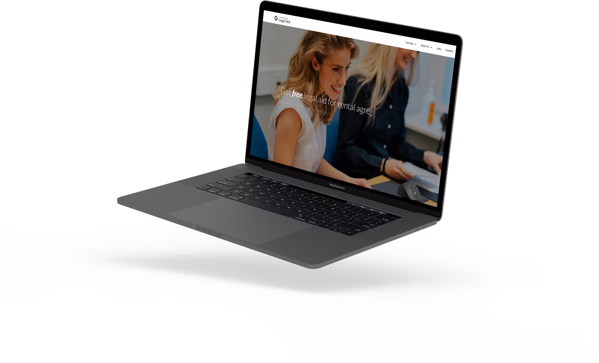 MacBook Pro showing a website about free legal aid with two women smiling and working.