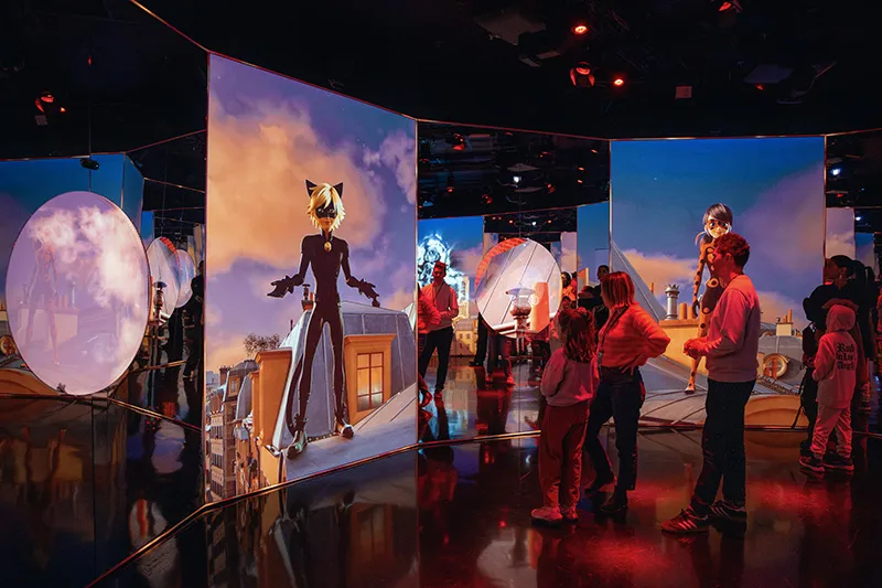 Silhouettes of six people watching a glowing purple sphere with a comforting figure and a seated girl inside, against a radiant purple backdrop.