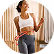 Smiling woman in athletic wear holding a skipping rope.