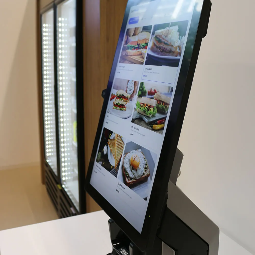 Touchscreen menu kiosk displaying sandwich options in a modern food service setting.