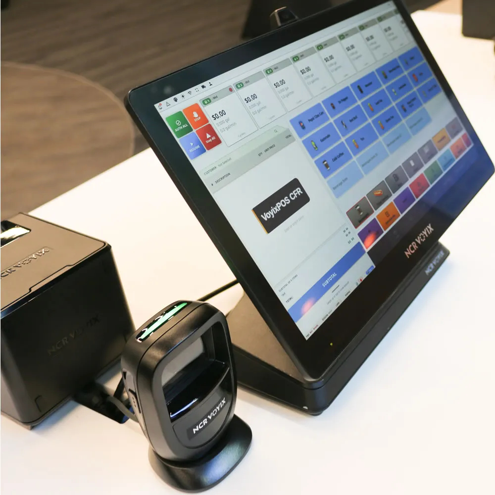 Point-of-sale system with touchscreen display showing VoyixPOS software and attached NCR Voyix barcode scanner.