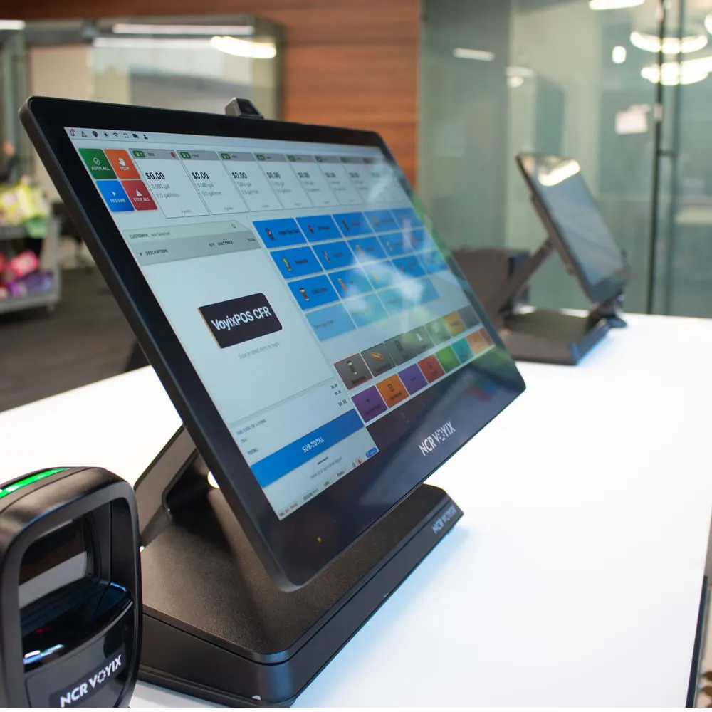 Touchscreen POS system with VoiyxPOS CFR software on a white counter in a retail space.