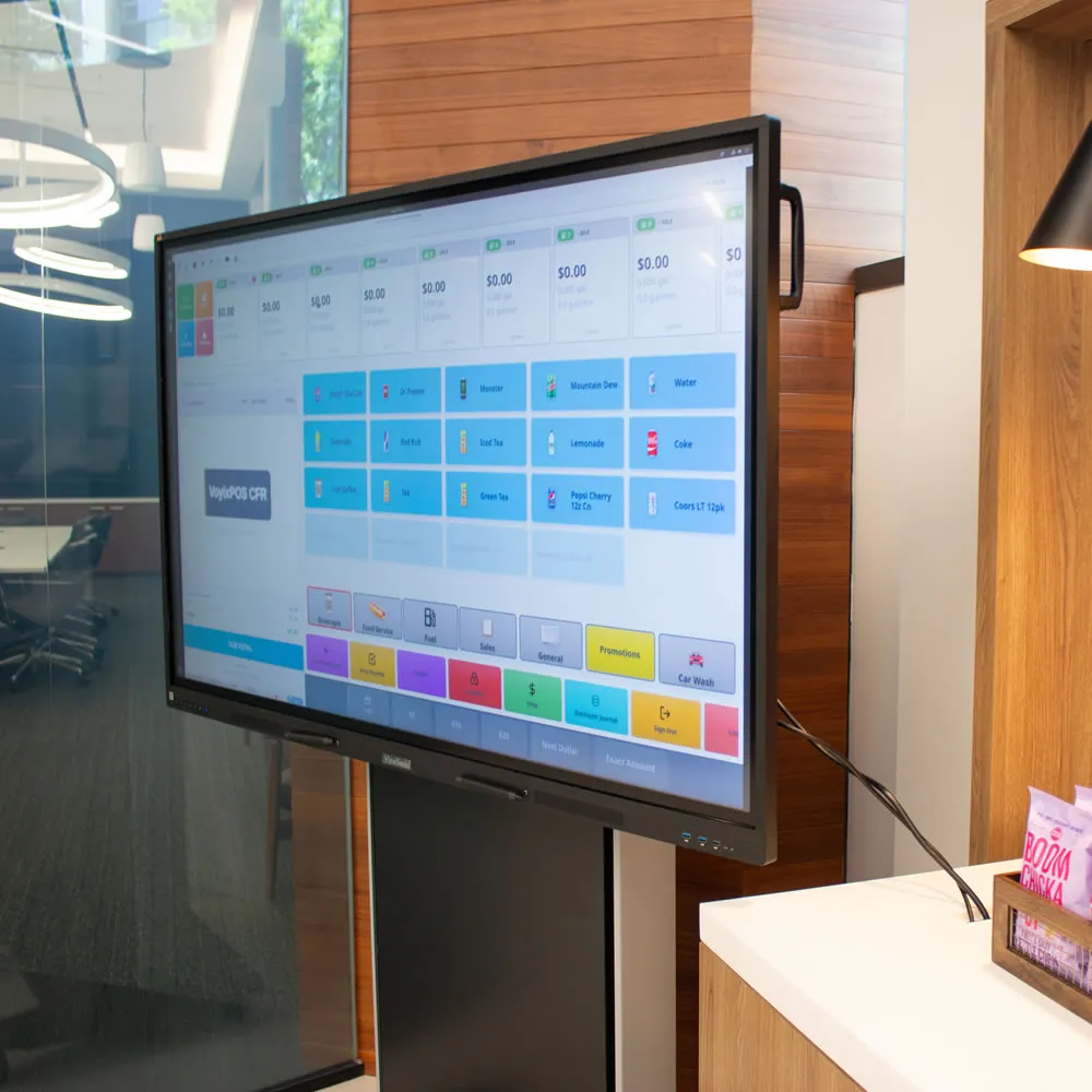 Large touchscreen monitor displaying a point-of-sale interface in a modern office setting.