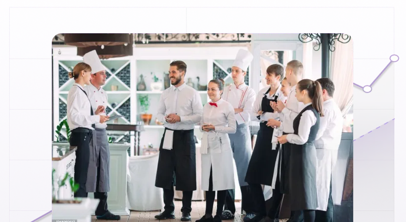 restaurant manger and head chef talking to waitstaff before restaurant opening