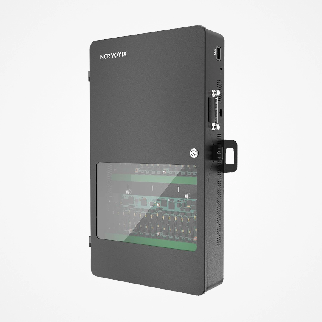 Black NCR Voyix hardware box with a transparent panel showing internal electronic components.