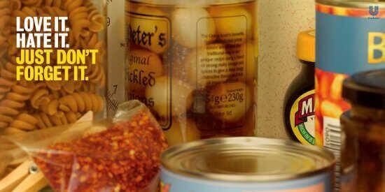 Marmite print ad showing a neglected jar of Marmite pushed to the back of a cluttered pantry shelf, forgotten behind other products