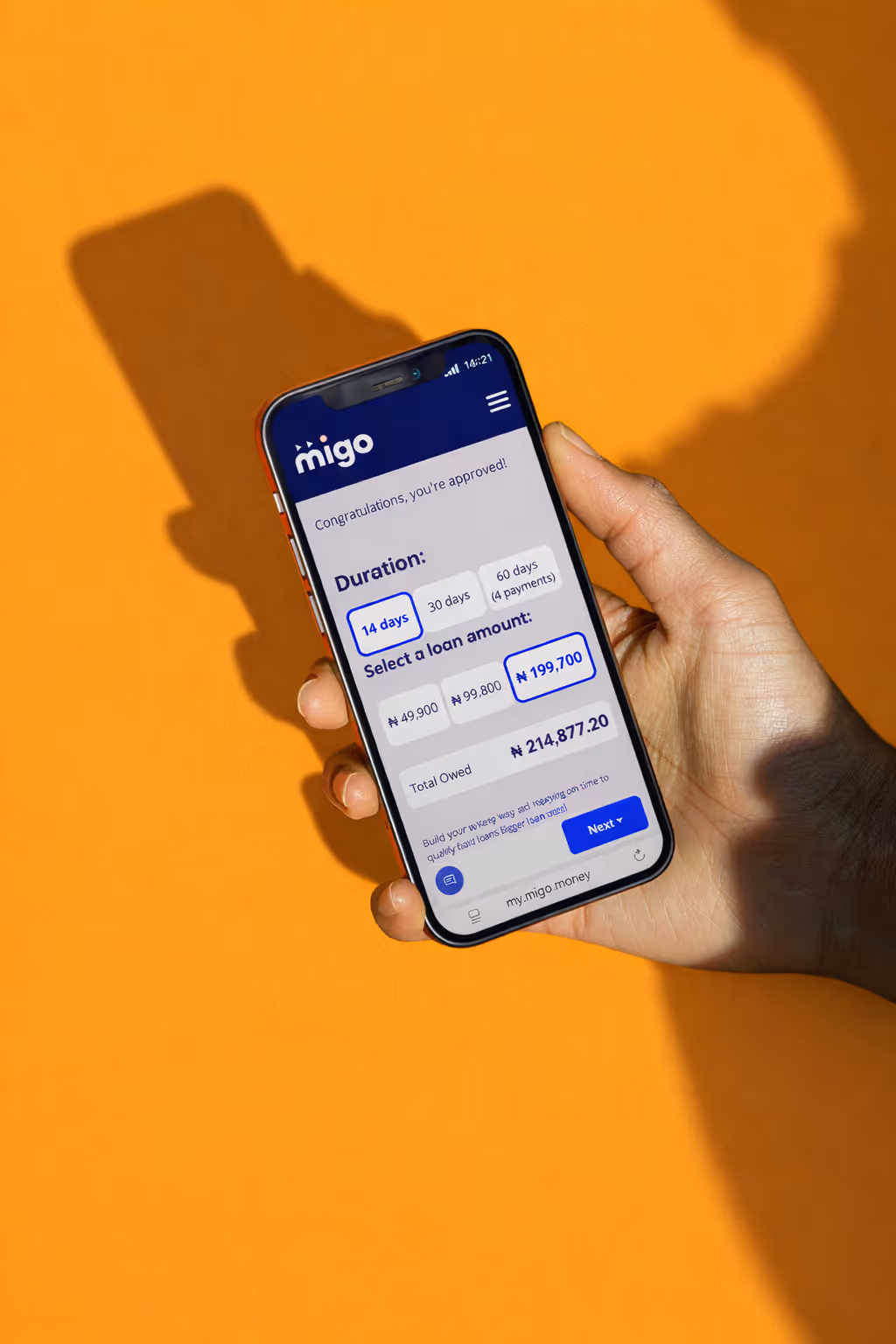 Close-up of a person holding a smartphone displaying a loan selection app with options for duration and loan amount.