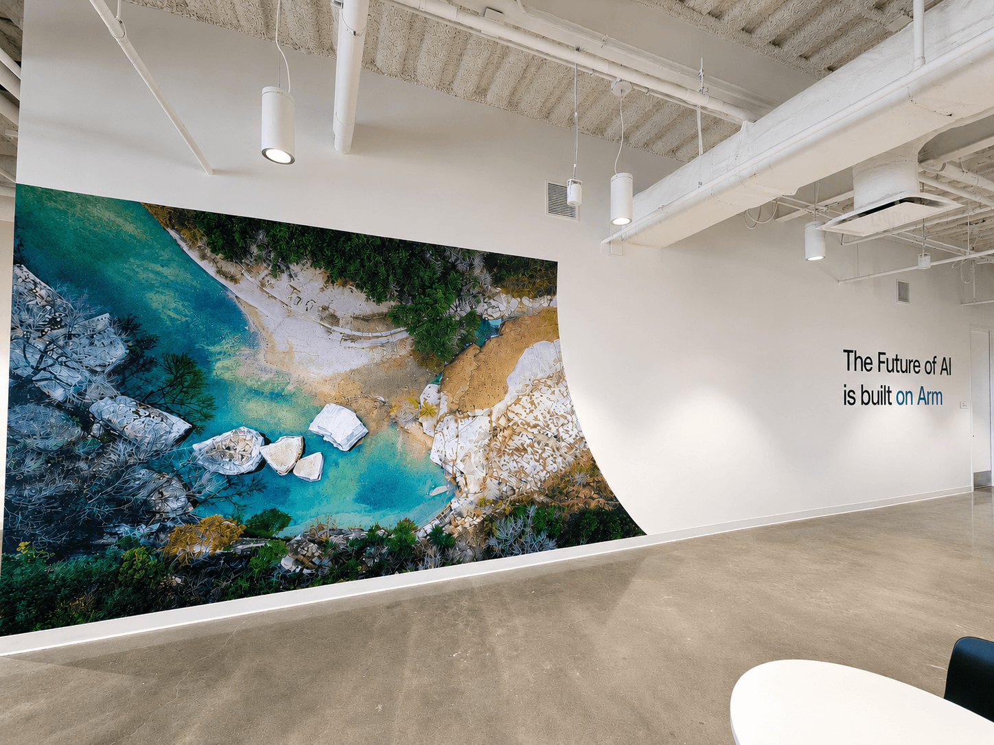 Aerial landscape wall mural beside a built-on-Arm graphic in an office corridor