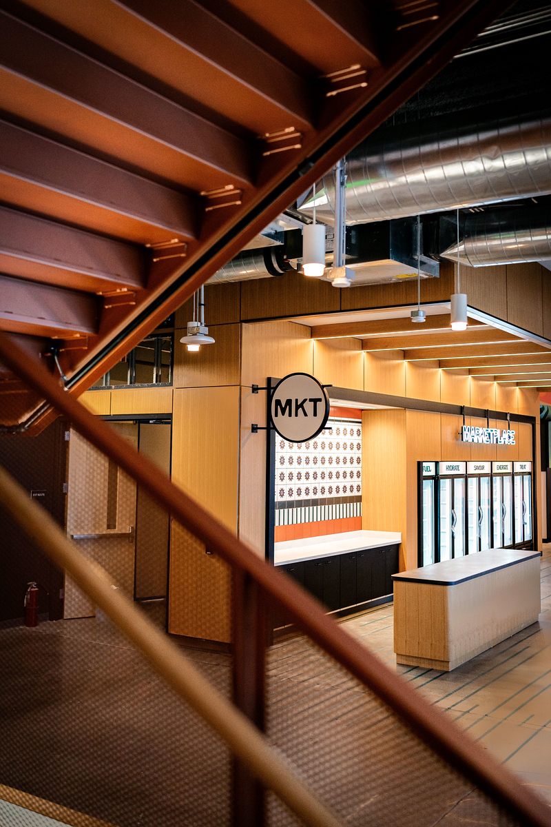 Circular MKT blade sign above a marketplace kiosk in an Amazon office building