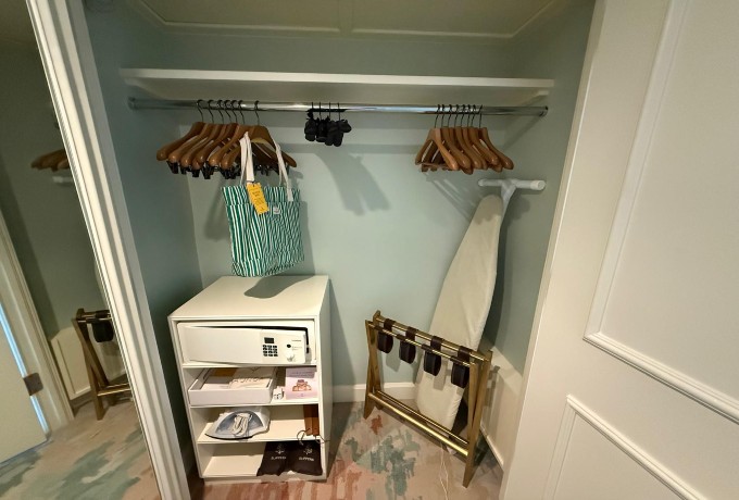 Guest room closet at Four Seasons Resort Palm Beach with ironing board, extra hangers, in-room safe and other essentials