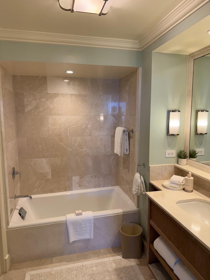 Room bathroom at Four Seasons Resort Palm Beach featuring a separate bathtub and spacious vanity unit