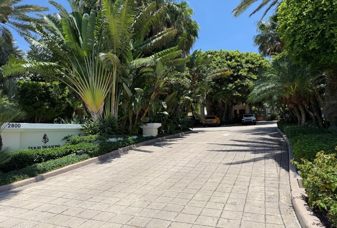 Main entrance of Four Seasons Resort Palm Beach with tropical landscaping.