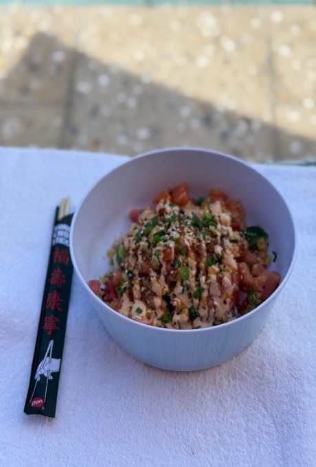 Spiced salmon poke bowl served at the poolside dining area of Four Seasons Palm Beach