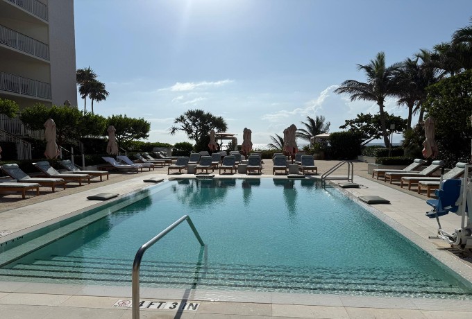 Adults-only pool at Four Seasons Resort Palm Beach with private lounge chairs and a tranquil setting