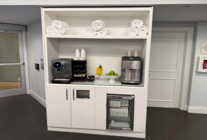 Refreshment center in the gym at Four Seasons Palm Beach with coffee machine, water dispenser and fresh fruit